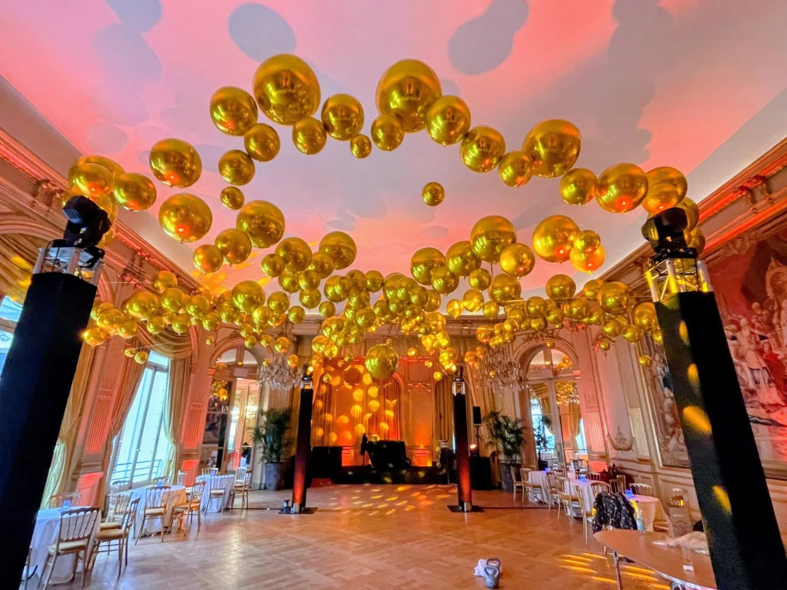 Gold and chrome balloon installation in a Parisian ballroom at Cercle Interallié