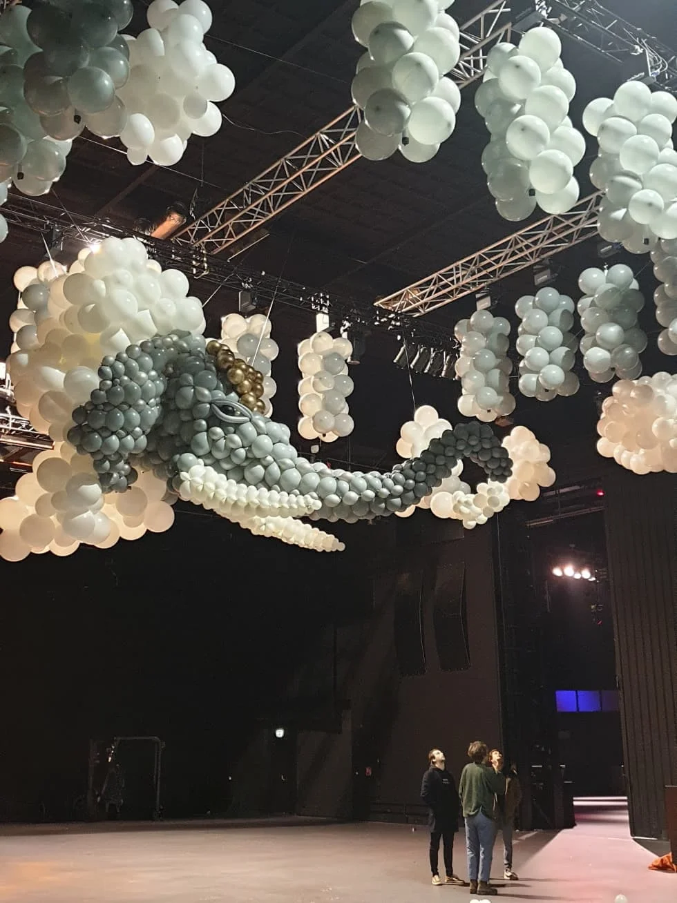 Kinetic balloon elephant sculpture suspended from ceiling